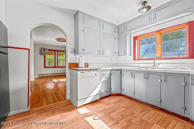 a kitchen with granite countertop cabinets stainless steel appliances and a window