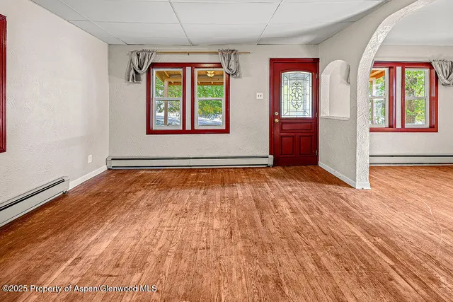 wooden floor in an empty room with a window