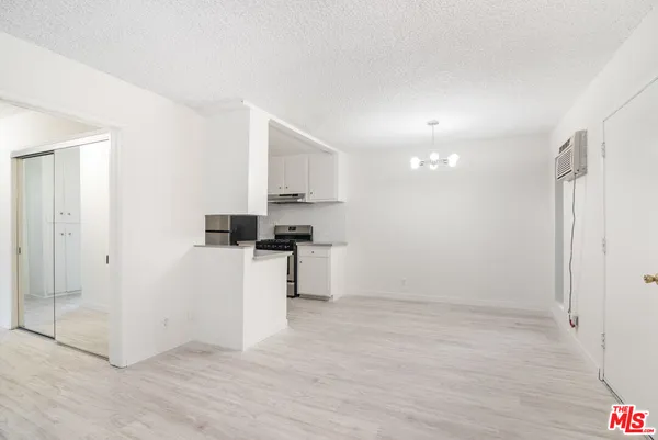 a kitchen with granite countertop a sink stove and refrigerator