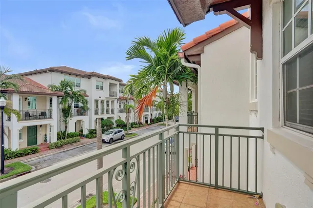 a view of a house with a small yard and plants