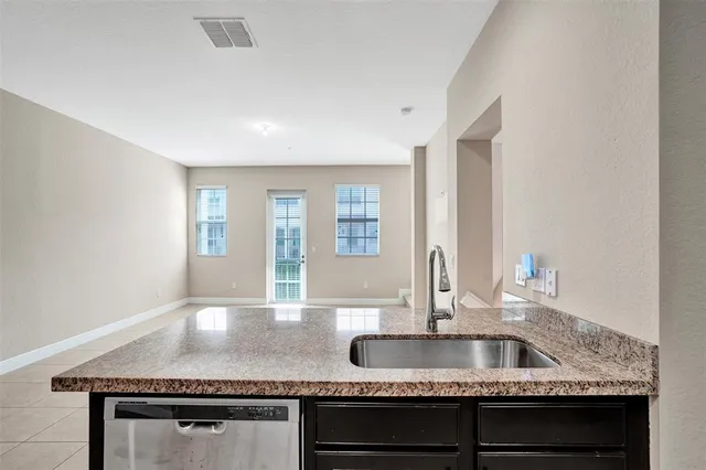 a kitchen with granite countertop a sink and a granite counter tops