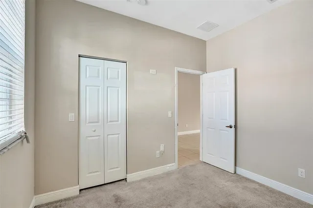 an empty room with closet area