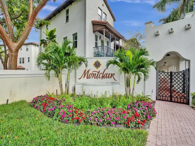 a sign that is in front of flowers