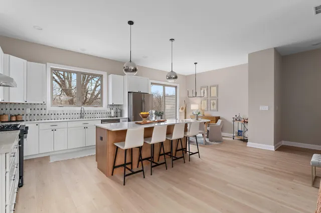 a room with white cabinets and wooden floor