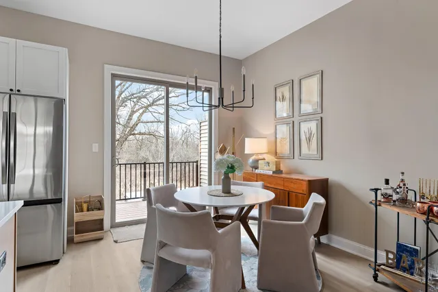 a dining room with furniture a chandelier and wooden floor