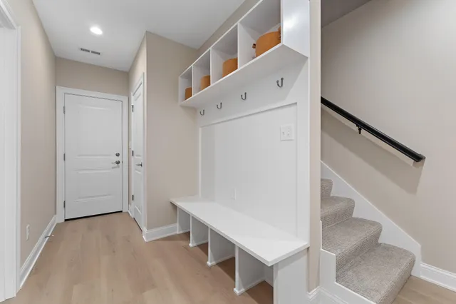 a view of entryway with stairs and wooden floor