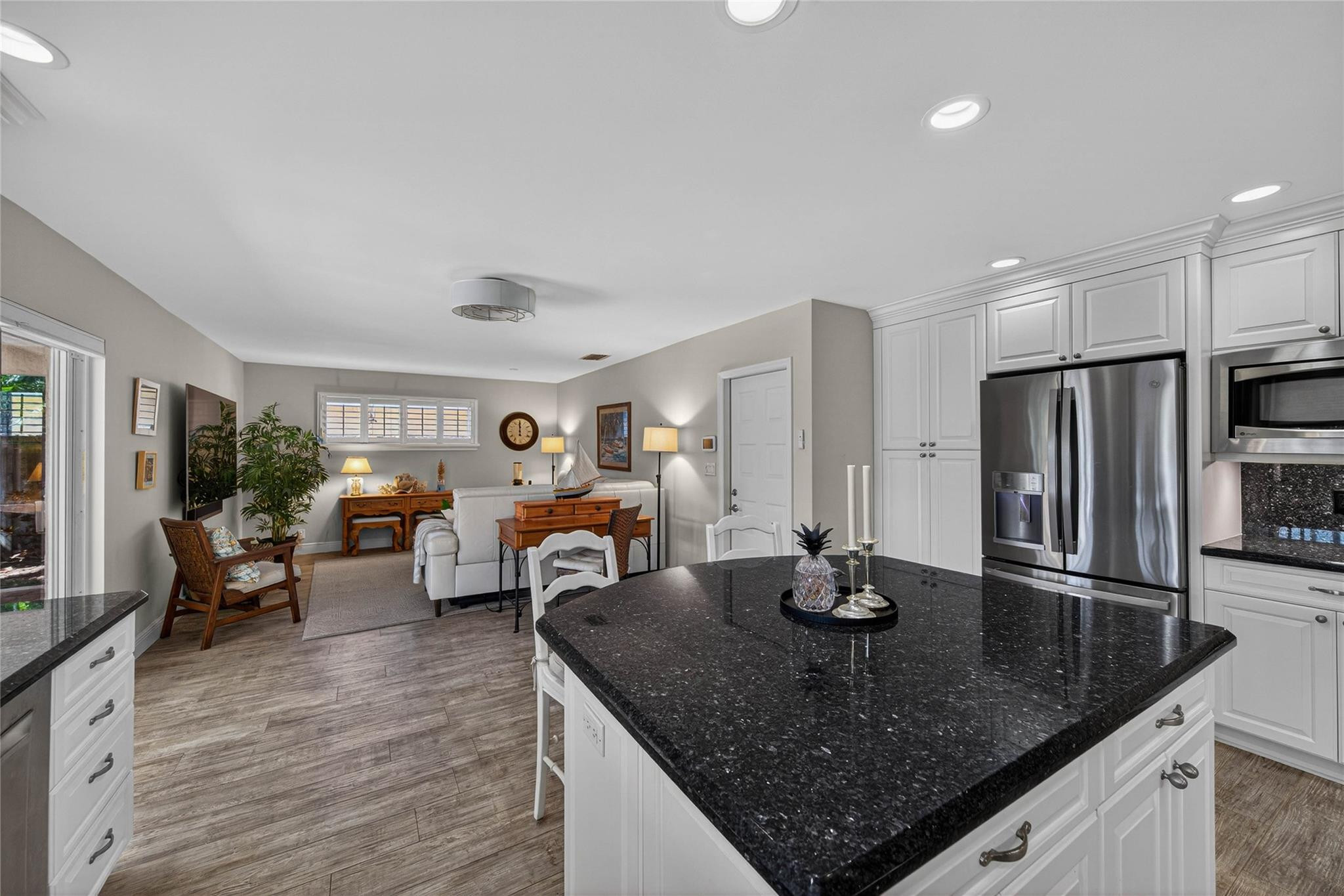 2600 Northeast 46th Street Lighthouse Point, FL 33064 - Photo 16 of 59 a kitchen with stainless steel appliances granite countertop a sink counter space and living room view