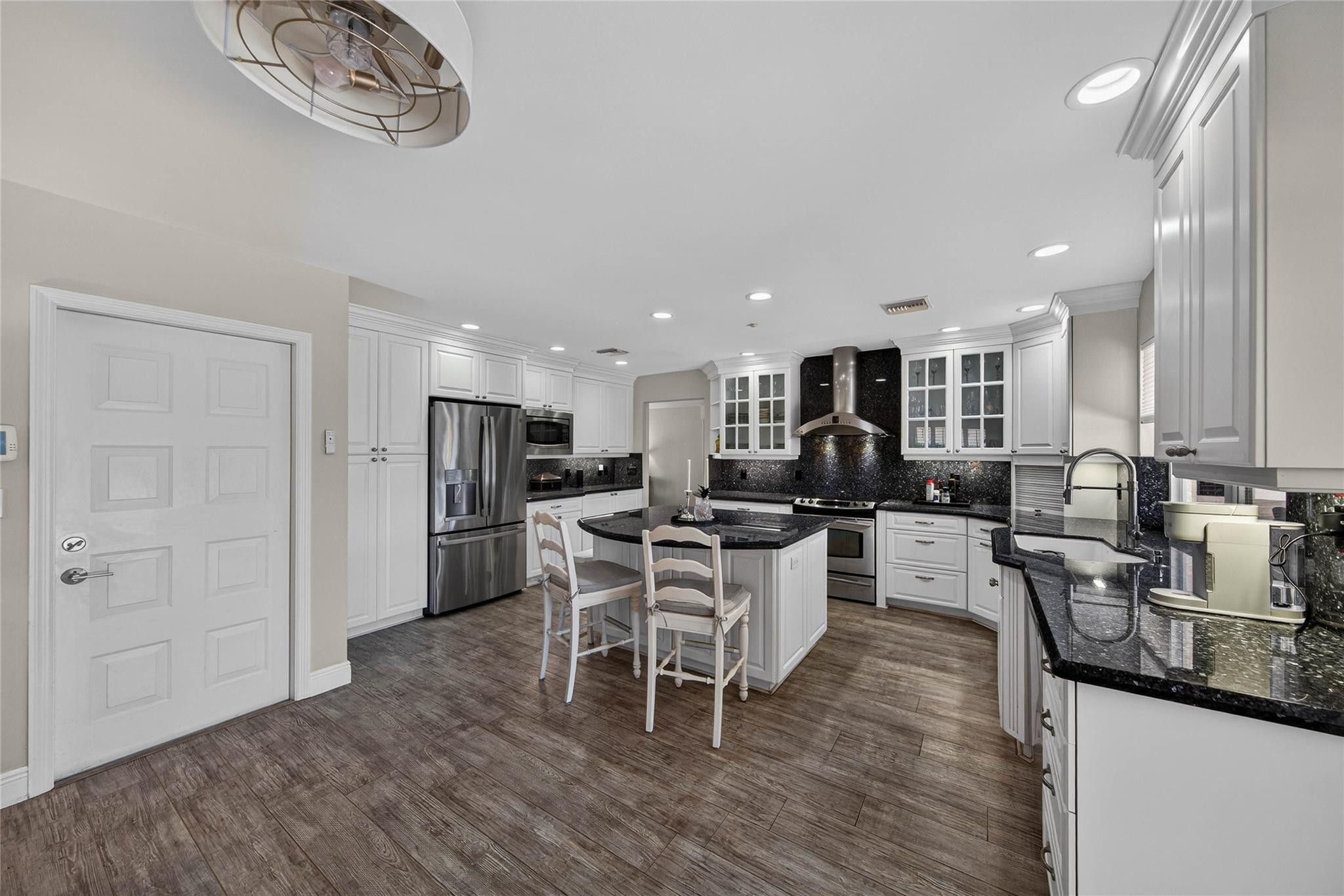 2600 Northeast 46th Street Lighthouse Point, FL 33064 - Photo 18 of 59 a living room with stainless steel appliances kitchen island granite countertop furniture wooden floor and a view of kitchen