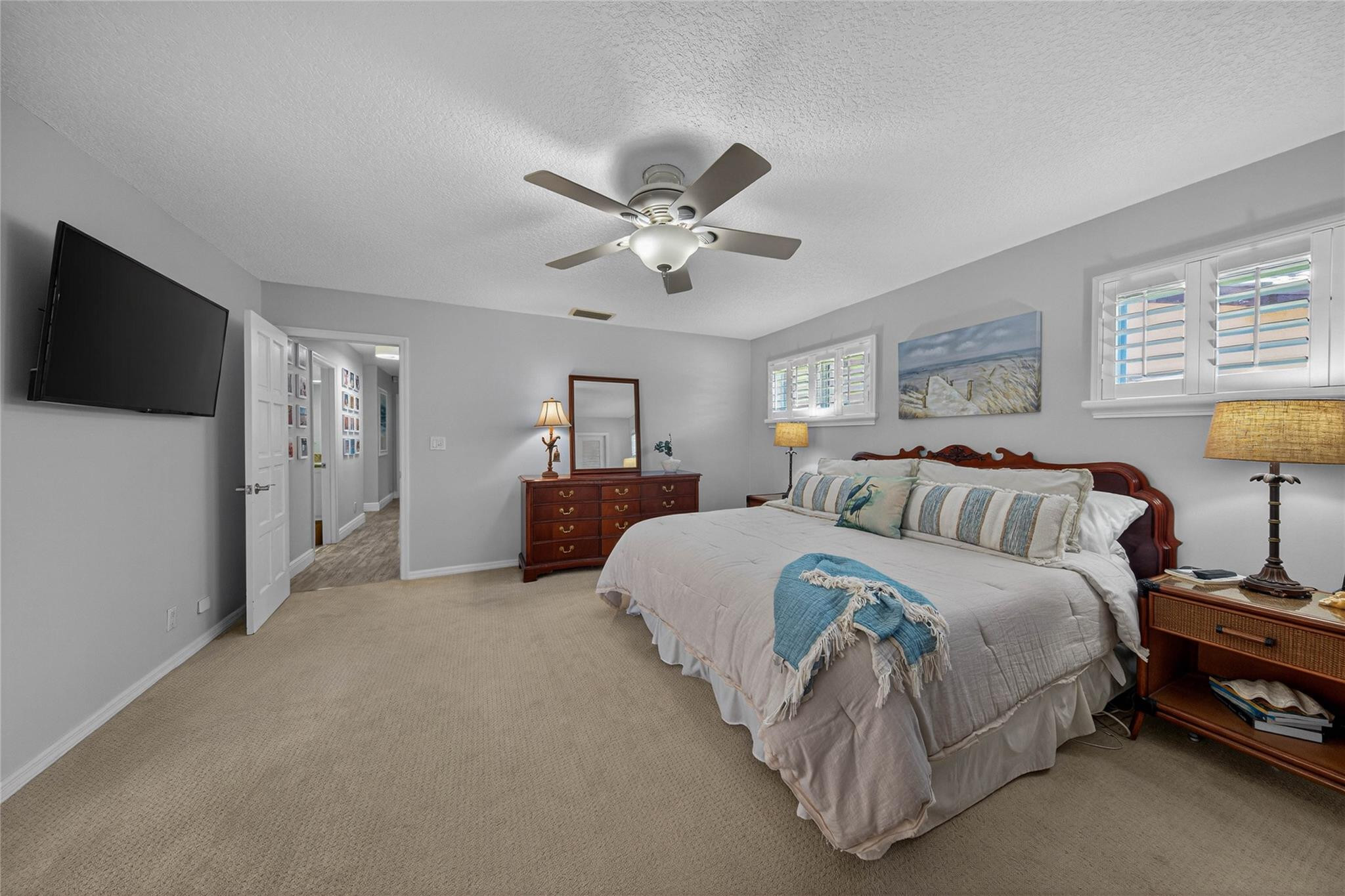 2600 Northeast 46th Street Lighthouse Point, FL 33064 - Photo 21 of 59 a spacious bedroom with a bed and a lamp