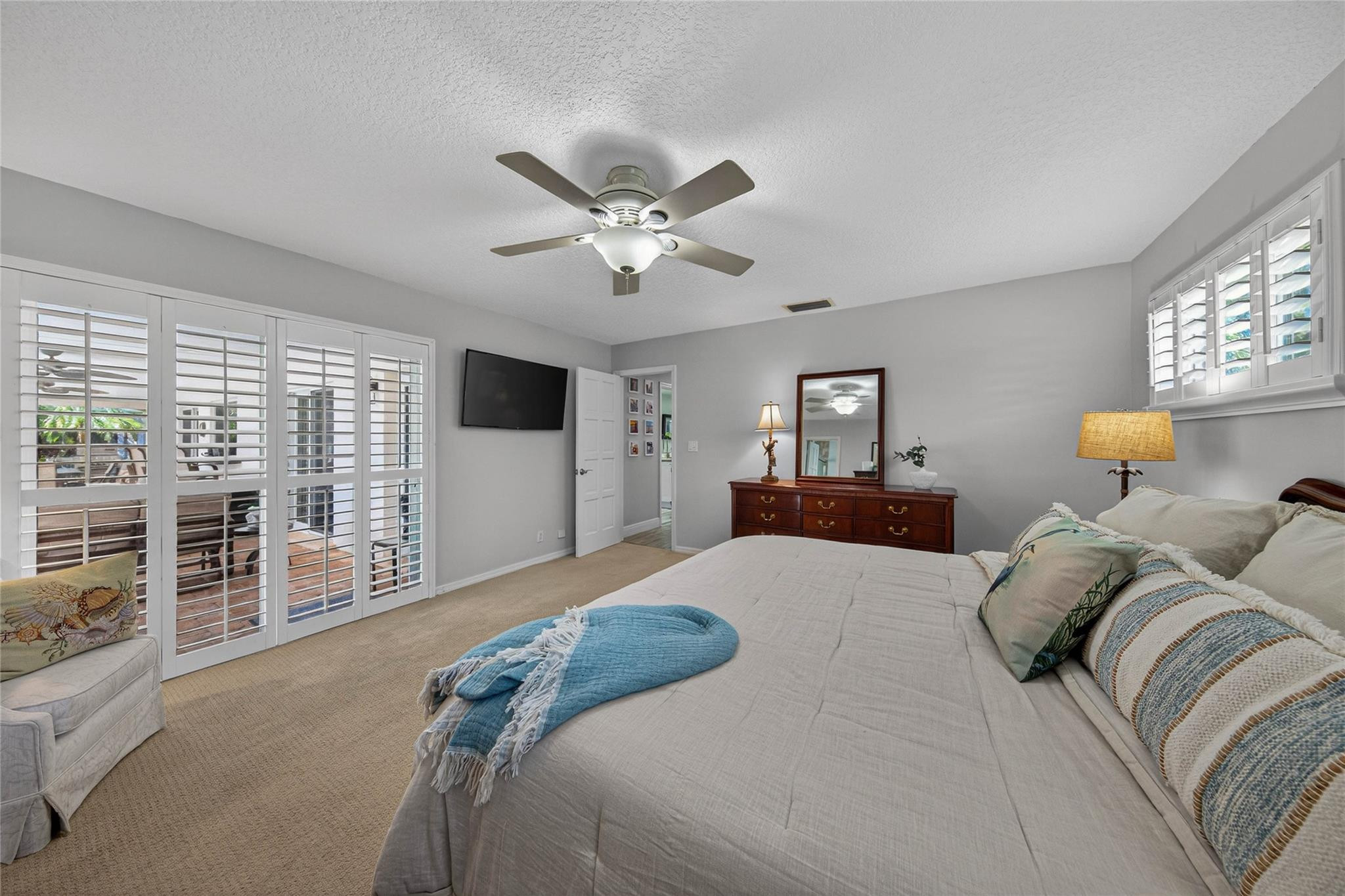 2600 Northeast 46th Street Lighthouse Point, FL 33064 - Photo 23 of 59 a bedroom with a large bed and a chandelier