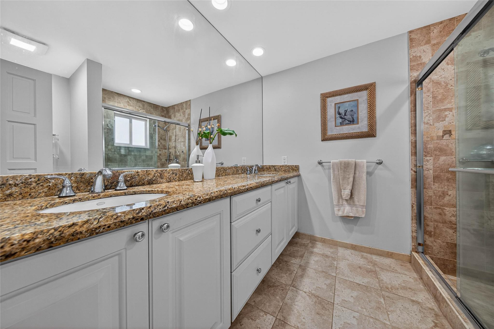 2600 Northeast 46th Street Lighthouse Point, FL 33064 - Photo 24 of 59 a spacious bathroom with a granite countertop sink a mirror and a