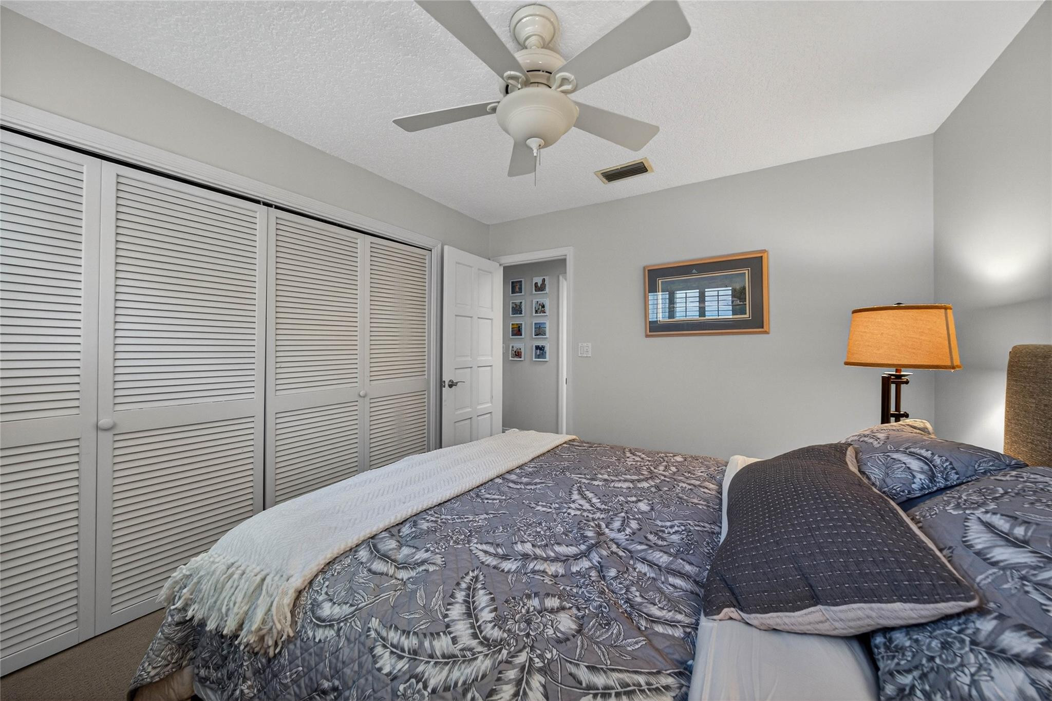 2600 Northeast 46th Street Lighthouse Point, FL 33064 - Photo 26 of 59 a bedroom with a bed and a lamp on dresser