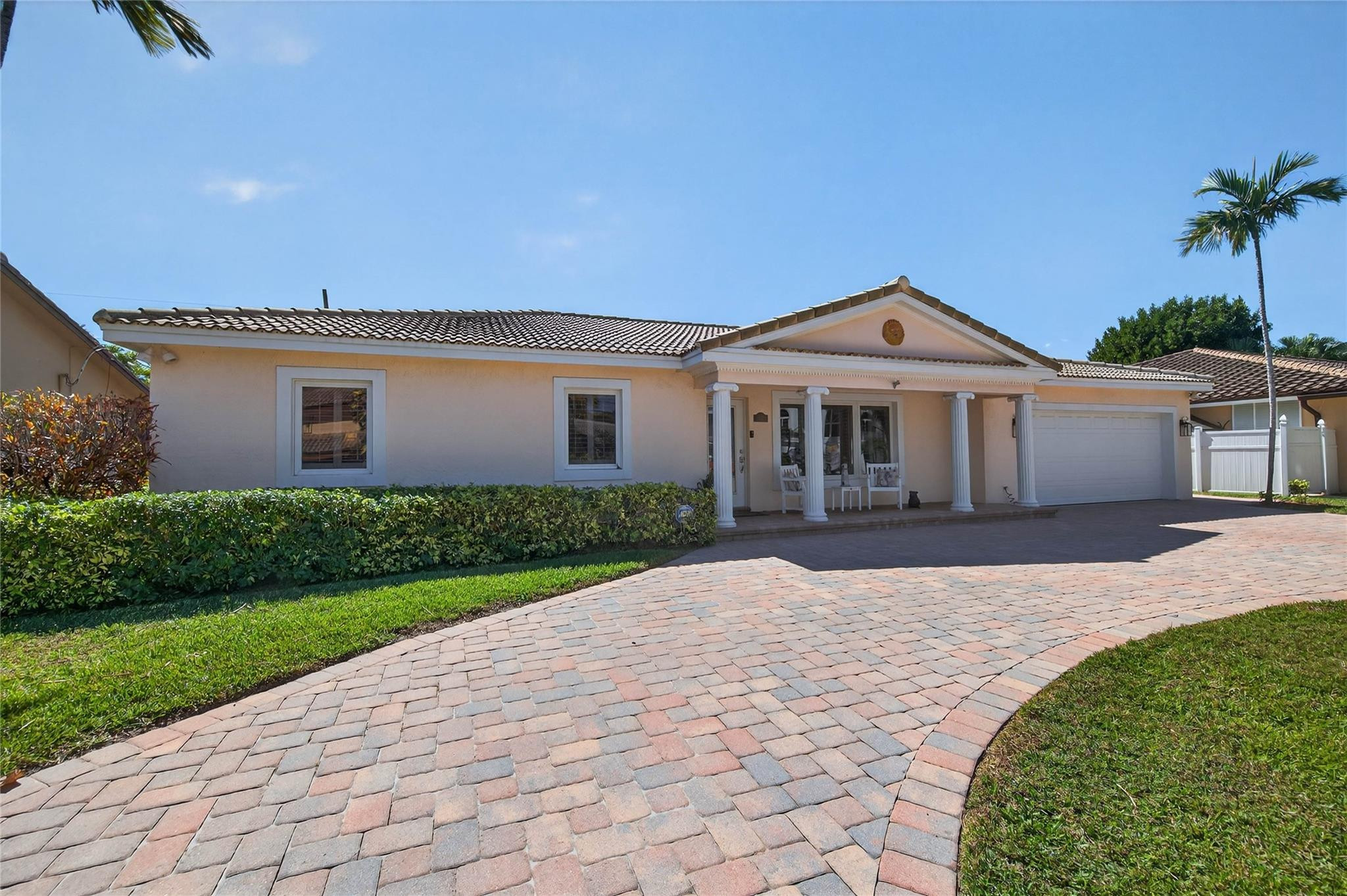 2600 Northeast 46th Street Lighthouse Point, FL 33064 - Photo 33 of 59 a front view of a house with a garden and yard