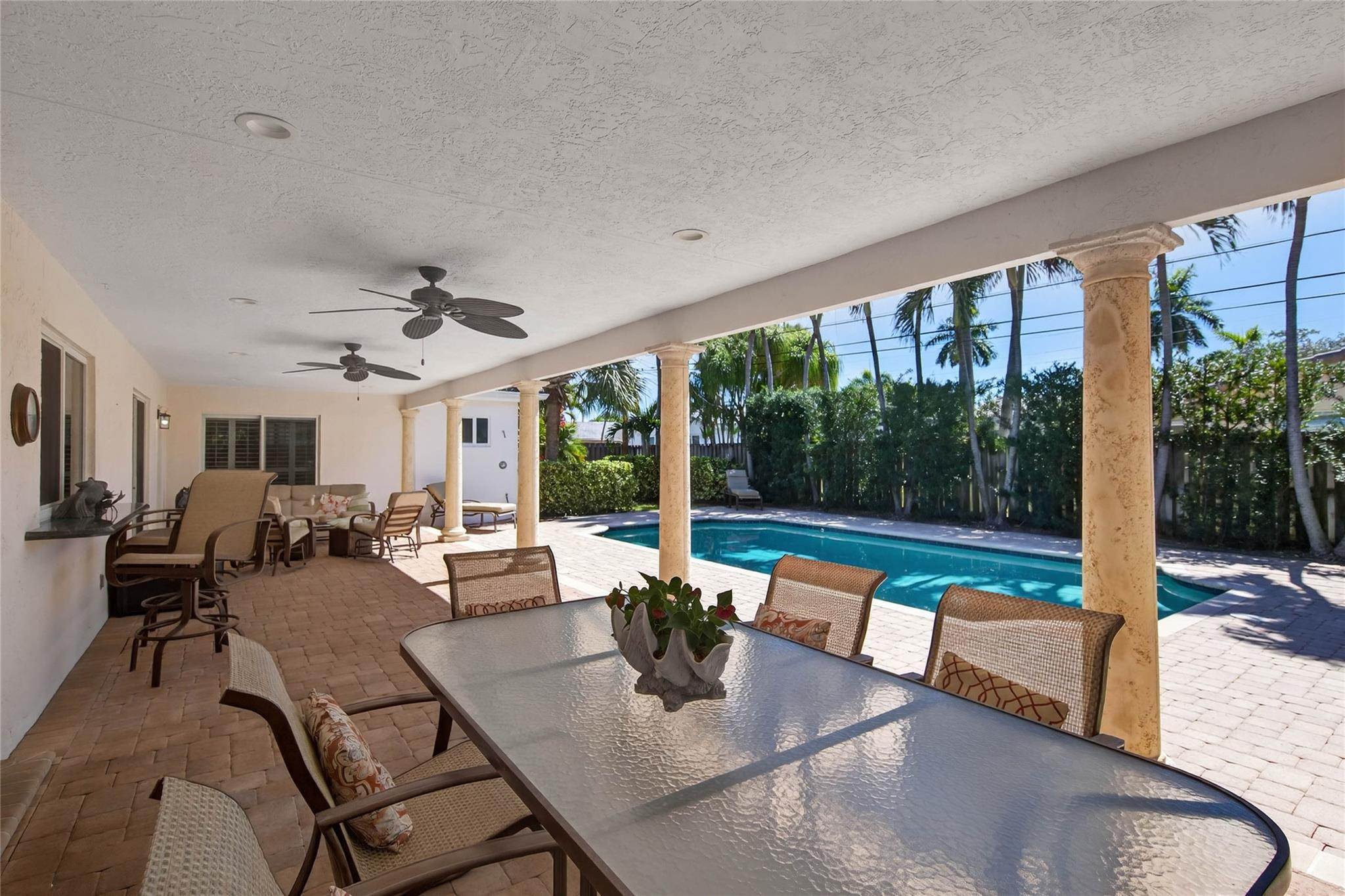2600 Northeast 46th Street Lighthouse Point, FL 33064 - Photo 4 of 59 a view of a dining room with furniture large windows and wooden floor