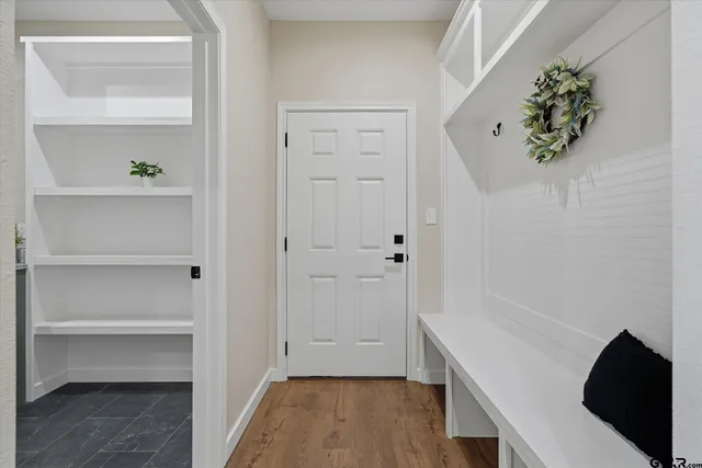 a view of an entryway with wooden floor