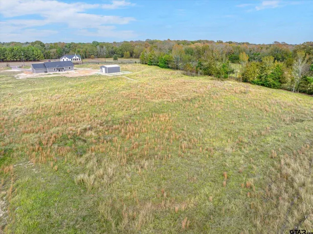 a view of a lake with a yard