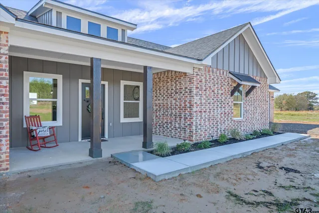a view of a house with wooden fence