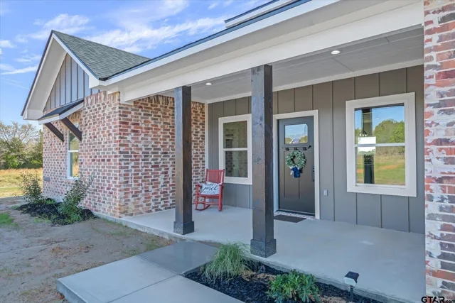 a front view of a house with a plants