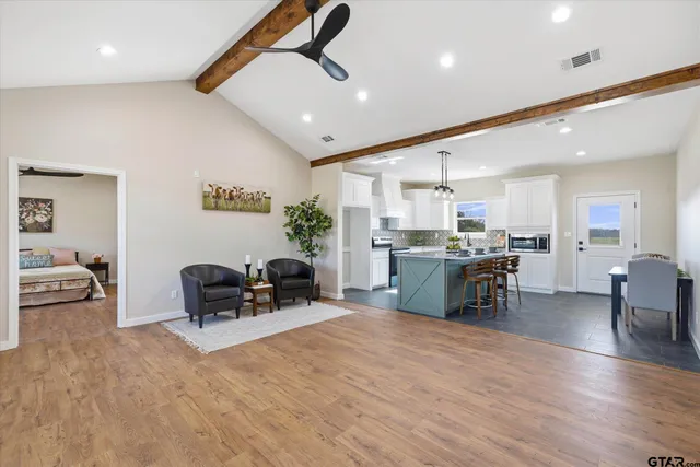 a living room with furniture and kitchen view