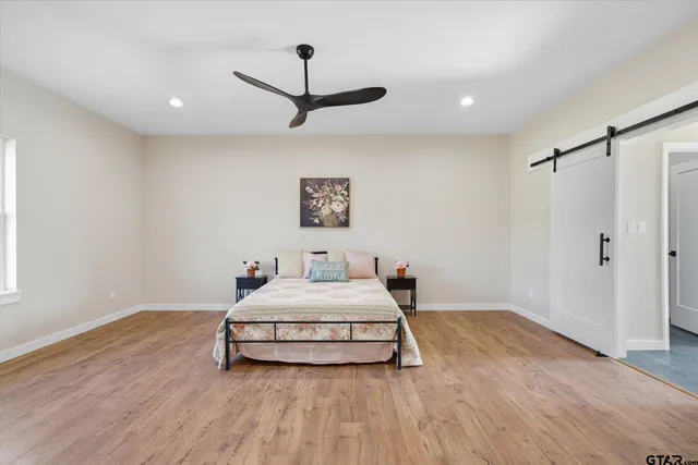 a bedroom with a bed and a ceiling fan