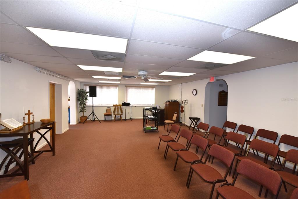 630 Union Street Dunedin, FL 34698 - Photo 18 of 37 a living room with furniture and a chandelier
