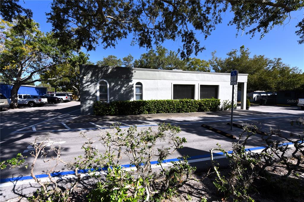 630 Union Street Dunedin, FL 34698 - Photo 2 of 37 a front view of a house with a yard and a garden
