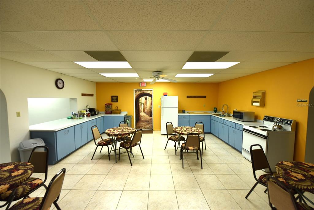 630 Union Street Dunedin, FL 34698 - Photo 22 of 37 a living room with couches a dining table and chairs with outer view