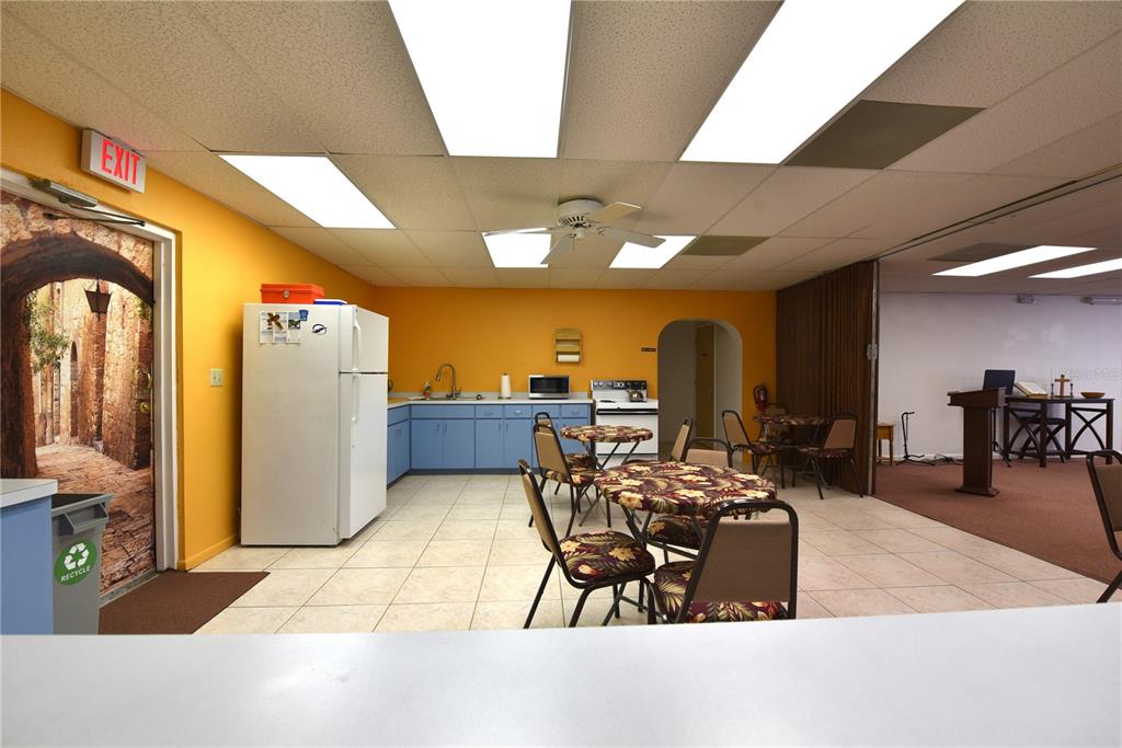 630 Union Street Dunedin, FL 34698 - Photo 24 of 37 a dining room with furniture and a chandelier