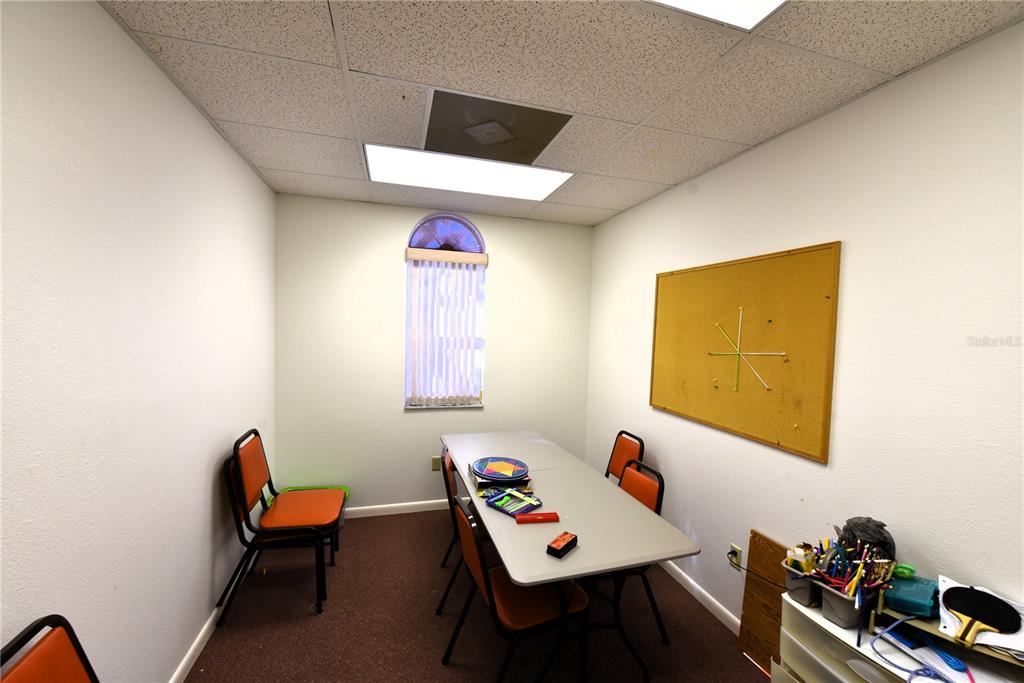 630 Union Street Dunedin, FL 34698 - Photo 32 of 37 a reading room with furniture a rug and a window