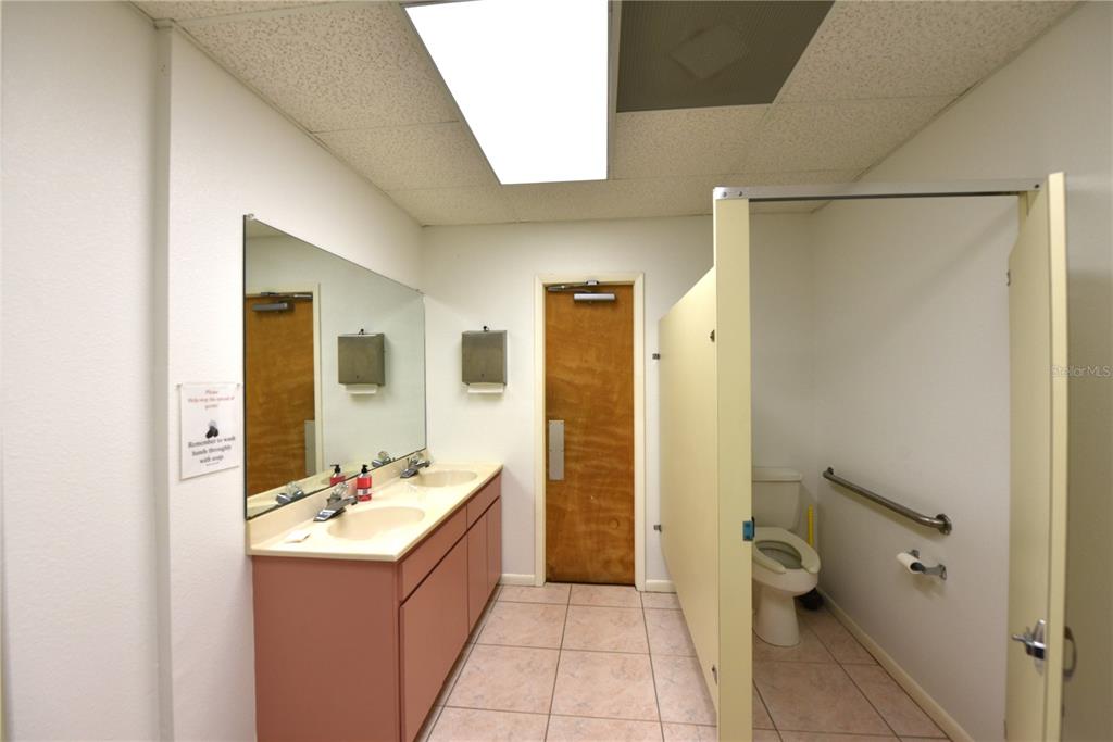 630 Union Street Dunedin, FL 34698 - Photo 35 of 37 a bathroom with a sink mirror and toilet