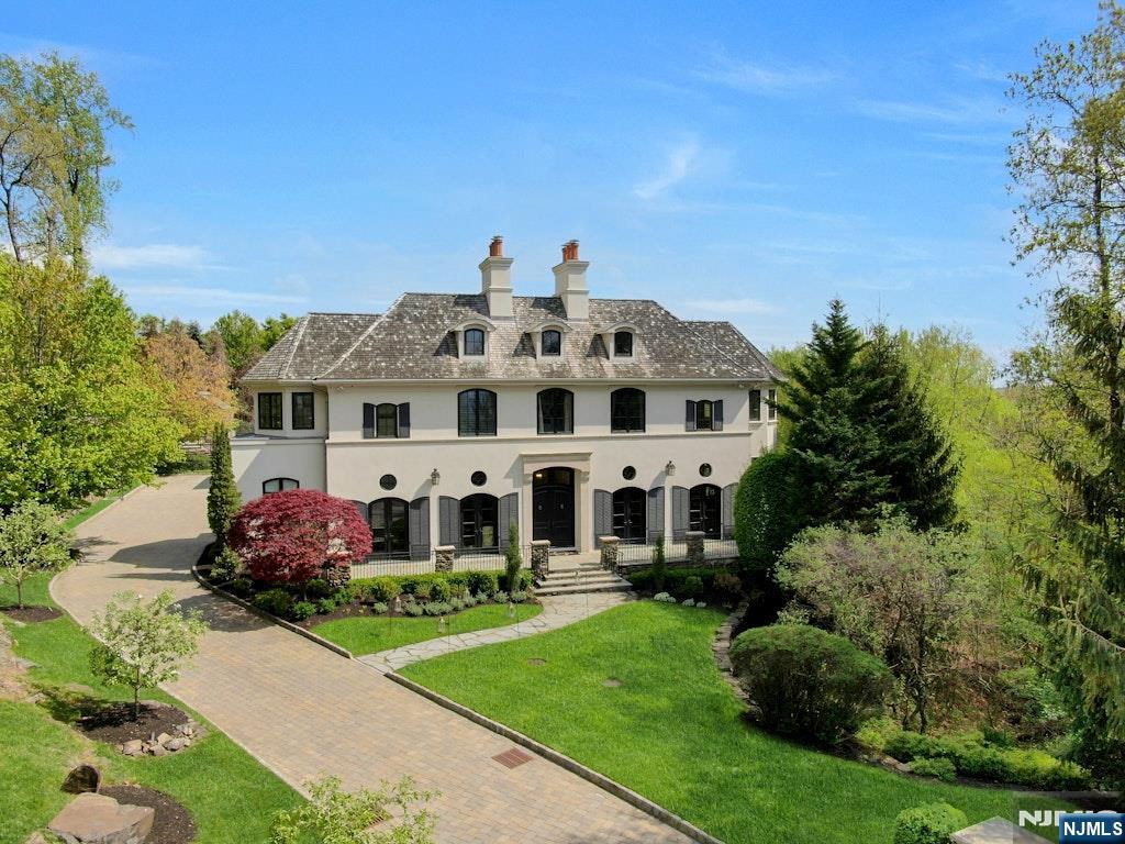 a large building with a big yard and large trees