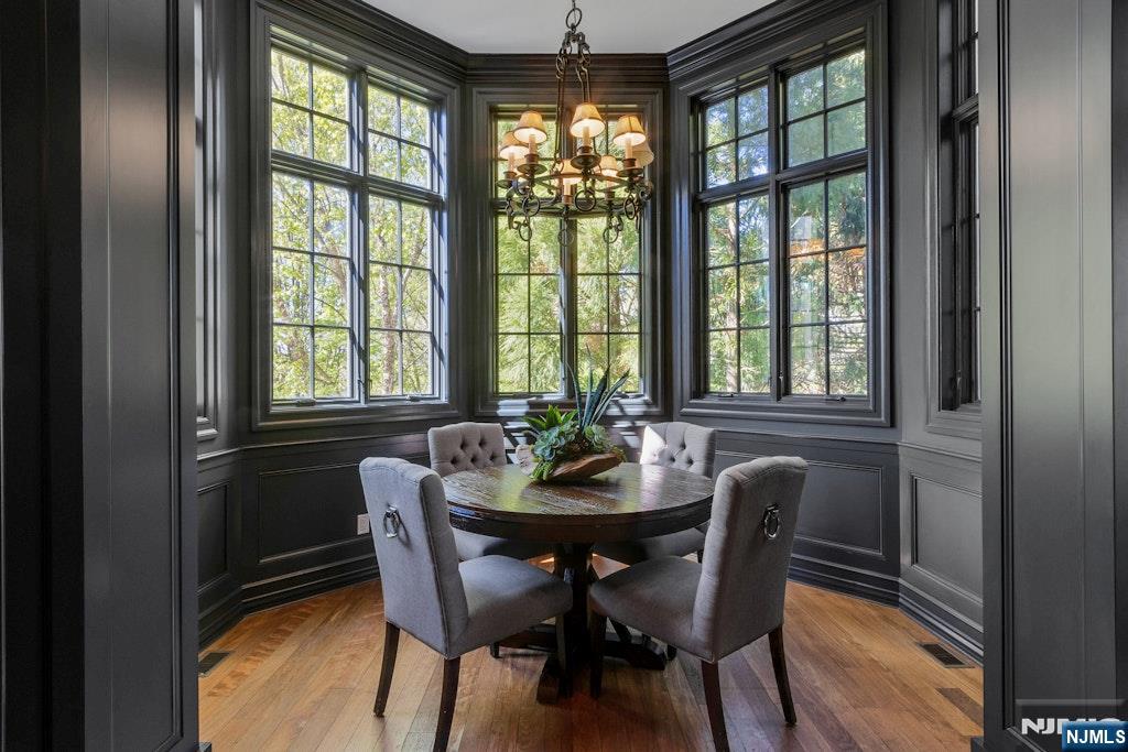 19 Autumn Terrace Alpine, NJ 07620 - Photo 12 of 45 a dining room with furniture a chandelier and wooden floor