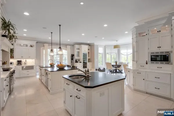 a kitchen with sink stove and cabinets