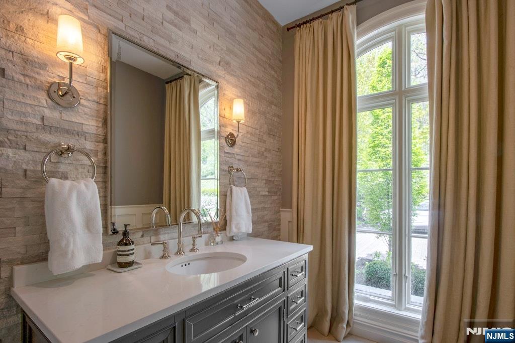19 Autumn Terrace Alpine, NJ 07620 - Photo 16 of 33 a bathroom with a sink and a mirror
