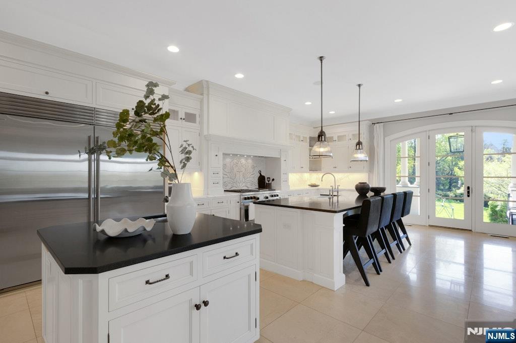 19 Autumn Terrace Alpine, NJ 07620 - Photo 19 of 45 a kitchen with granite countertop a table and chairs in it