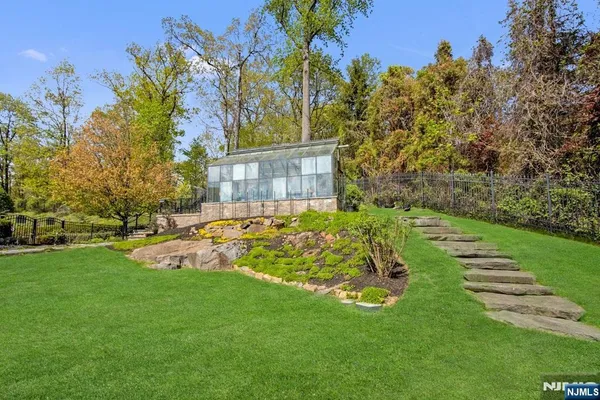 a view of a backyard with large trees