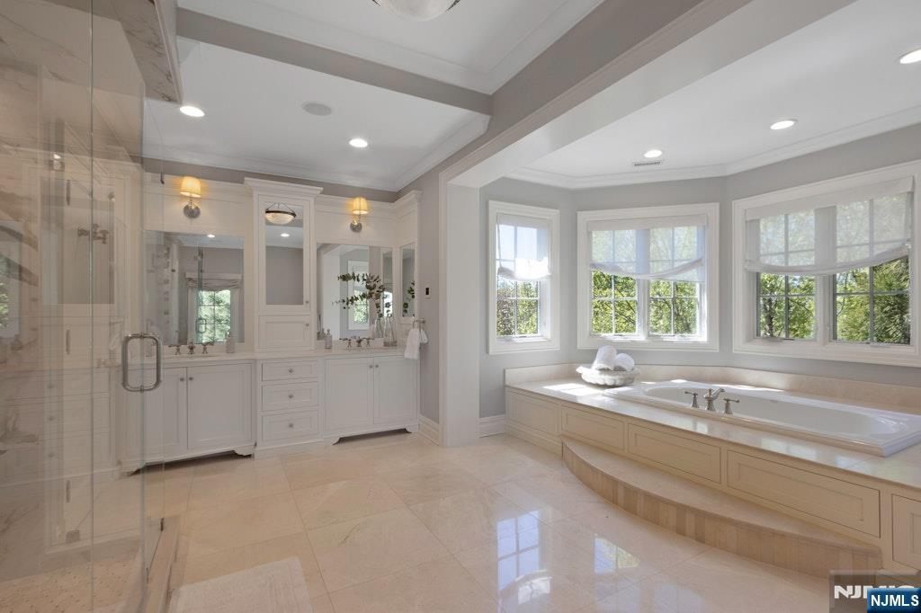 19 Autumn Terrace Alpine, NJ 07620 - Photo 36 of 45 a spacious bathroom with a tub a sink shower and a mirror