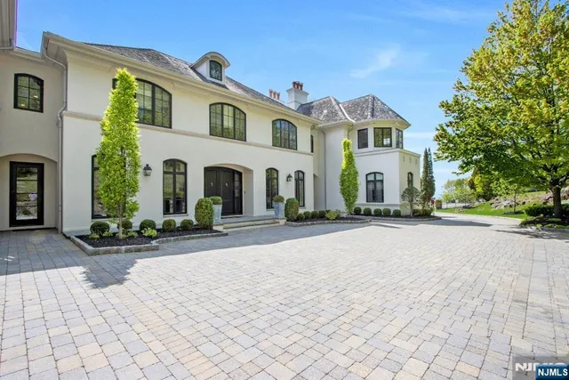 a front view of a house with a yard and a garage