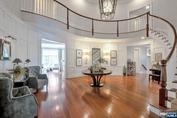a living room with furniture and a chandelier