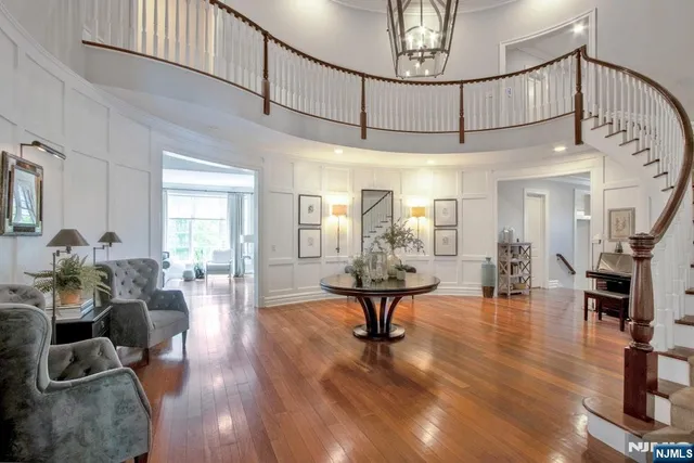 a living room with furniture and a chandelier