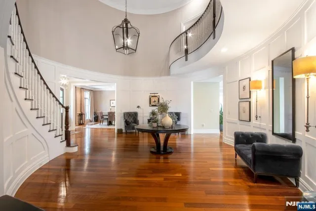 a living room with furniture and a chandelier