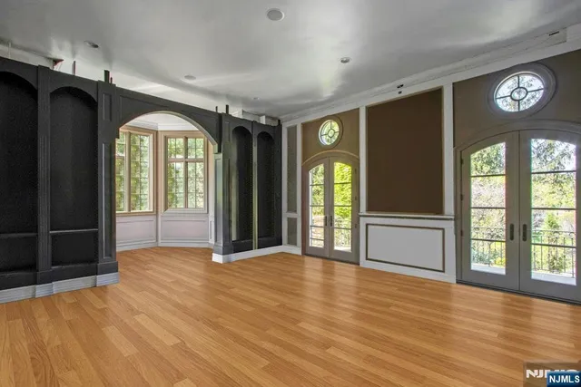 a view of an empty room with glass door and a window