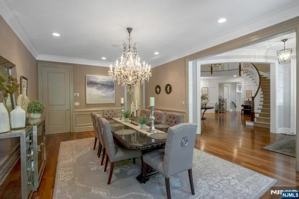 a dining room with furniture a chandelier and wooden floor