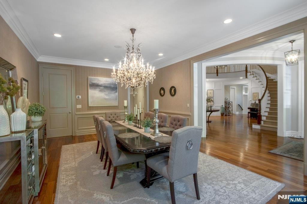 19 Autumn Terrace Alpine, NJ 07620 - Photo 9 of 33 a dining room with furniture a chandelier and wooden floor