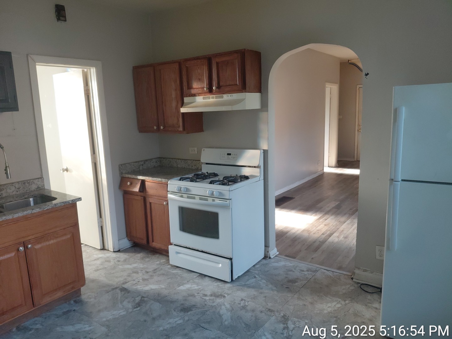 119 East 118th Street Chicago, IL 60628 - Photo 4 of 12 a kitchen with stainless steel appliances granite countertop a stove a refrigerator and a microwave