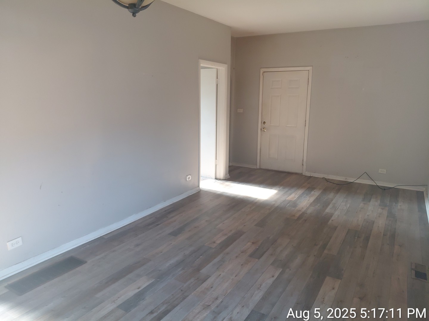 119 East 118th Street Chicago, IL 60628 - Photo 7 of 12 a view of an empty room with wooden floor