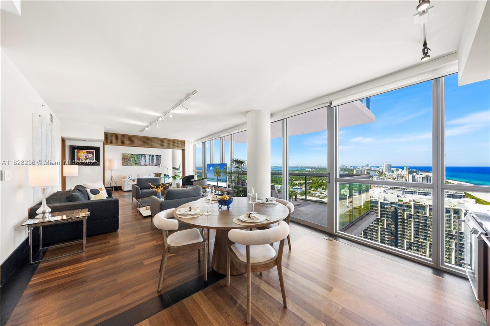101 20th Street, Unit 3803 Miami Beach, FL 33139 - Photo 11 of 36 a living room with furniture large windows and wooden floor