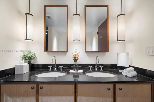 a spacious bathroom with a double vanity sink a mirror and a bathtub