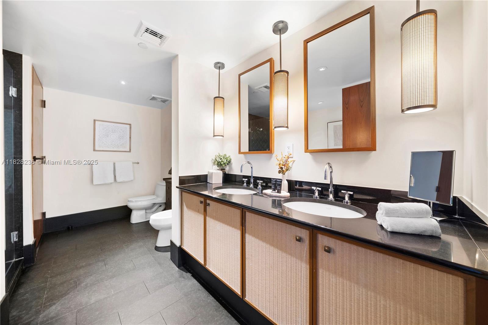 101 20th Street, Unit 3803 Miami Beach, FL 33139 - Photo 16 of 36 a spacious bathroom with a double vanity sink a mirror and a bathtub