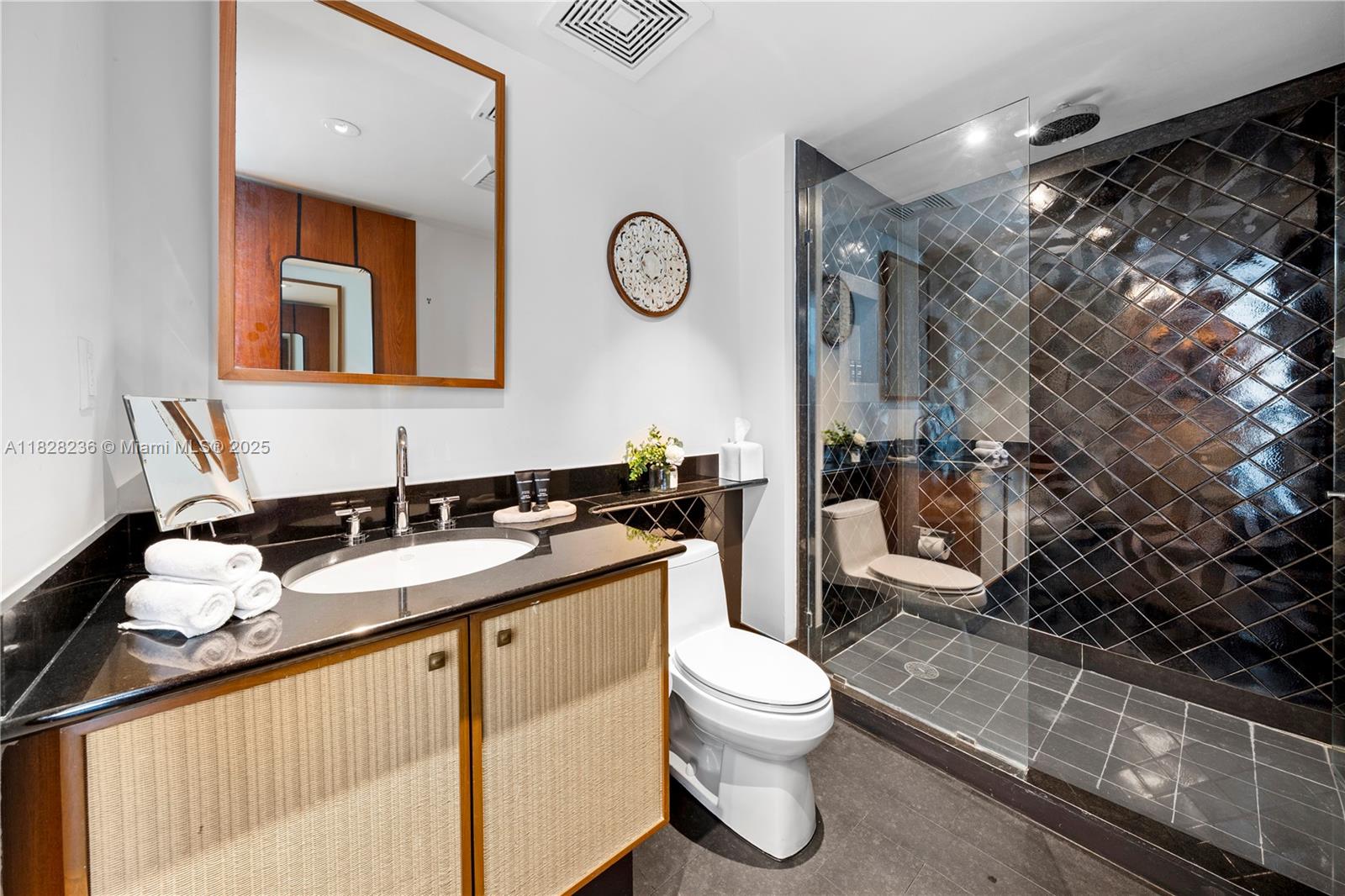 101 20th Street, Unit 3803 Miami Beach, FL 33139 - Photo 22 of 36 a bathroom with a granite countertop sink mirror vanity and toilet